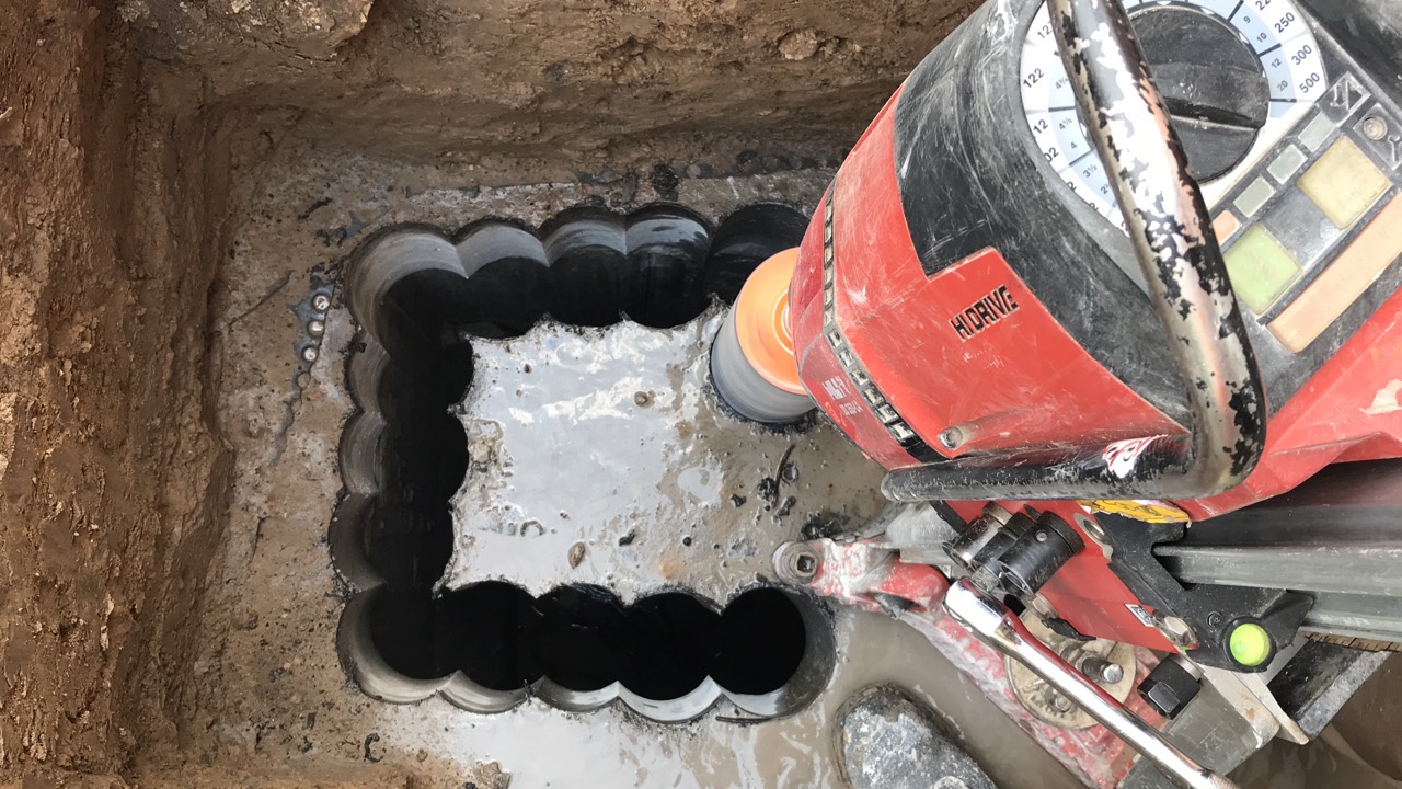 concrete-coring-with-hilti-dd-drill making an opening in the sewage system by drilling out concrete